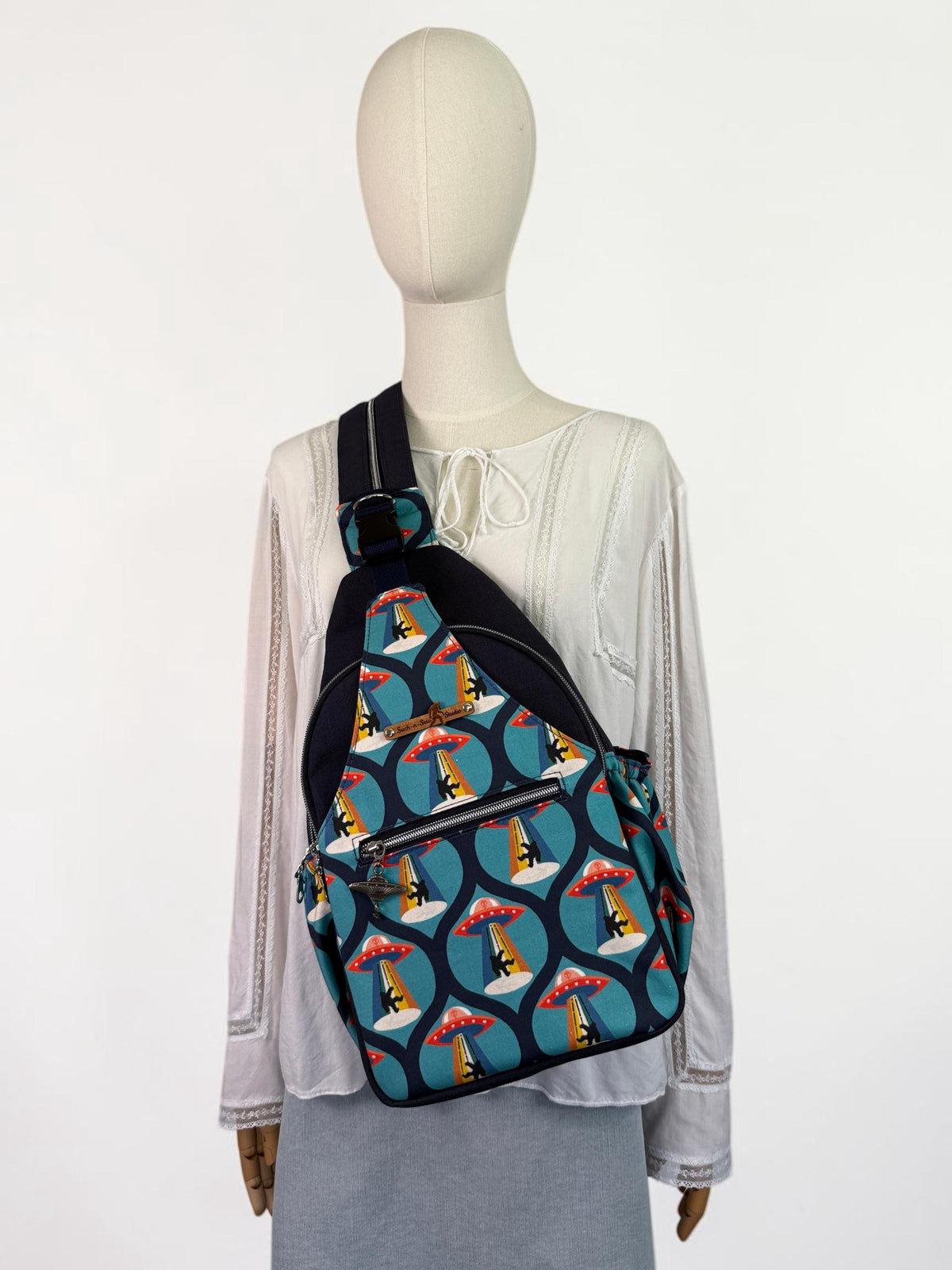 Groovy Alien Abducting Bigfoot Convertible Backpack Crossbody Sling