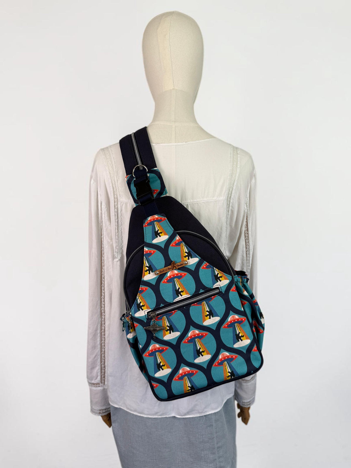 Groovy Alien Abducting Bigfoot Convertible Backpack Crossbody Sling