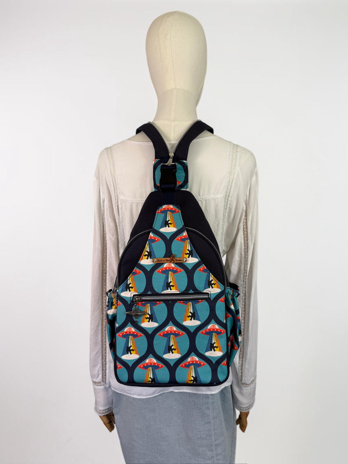 Groovy Alien Abducting Bigfoot Convertible Backpack Crossbody Sling