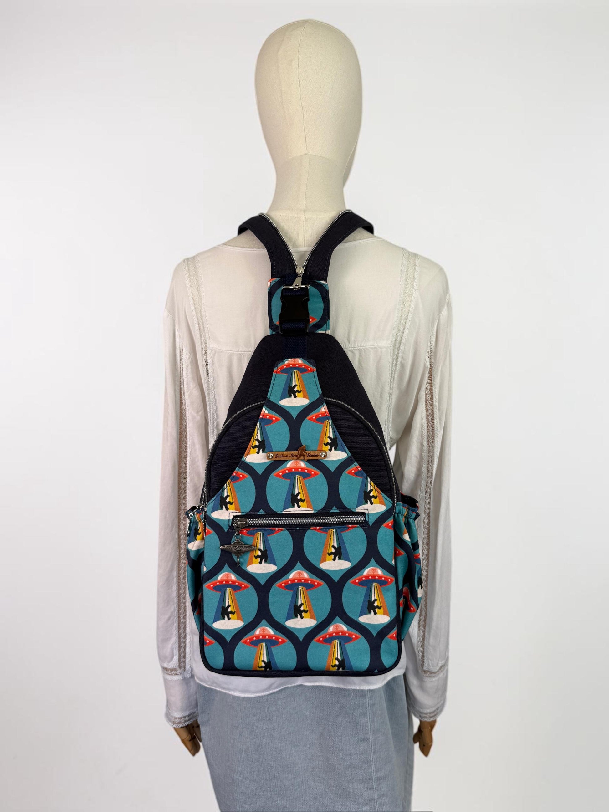 Groovy Alien Abducting Bigfoot Convertible Backpack Crossbody Sling
